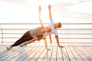 couple working on yoga poses for stress