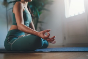 women working on her meditate at home