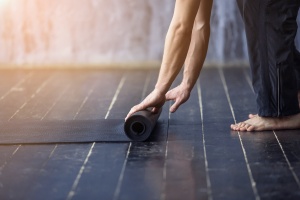 women rolling mat after working on Yoga Breath