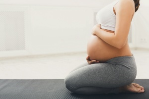 women holding her belly doing ayurveda practices