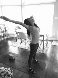 black and white image on woman at home on yoga mat