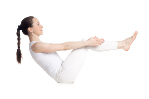 women in white outfit holding a leg and arm pose properly