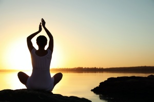 girl doing sraddha yoga in sunset