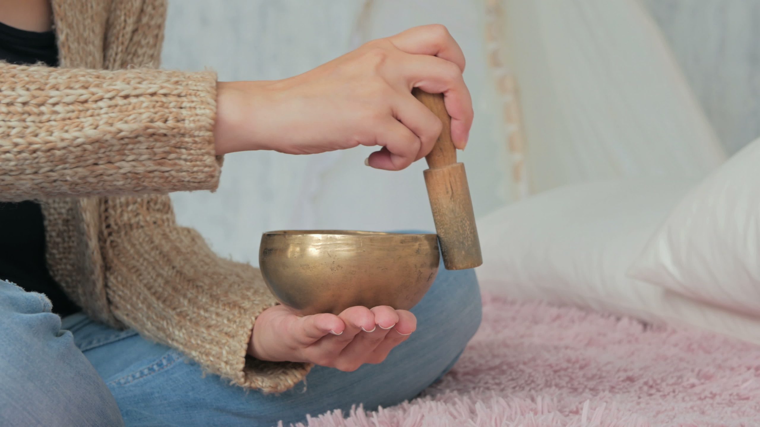 Person playing a sound healing bowl