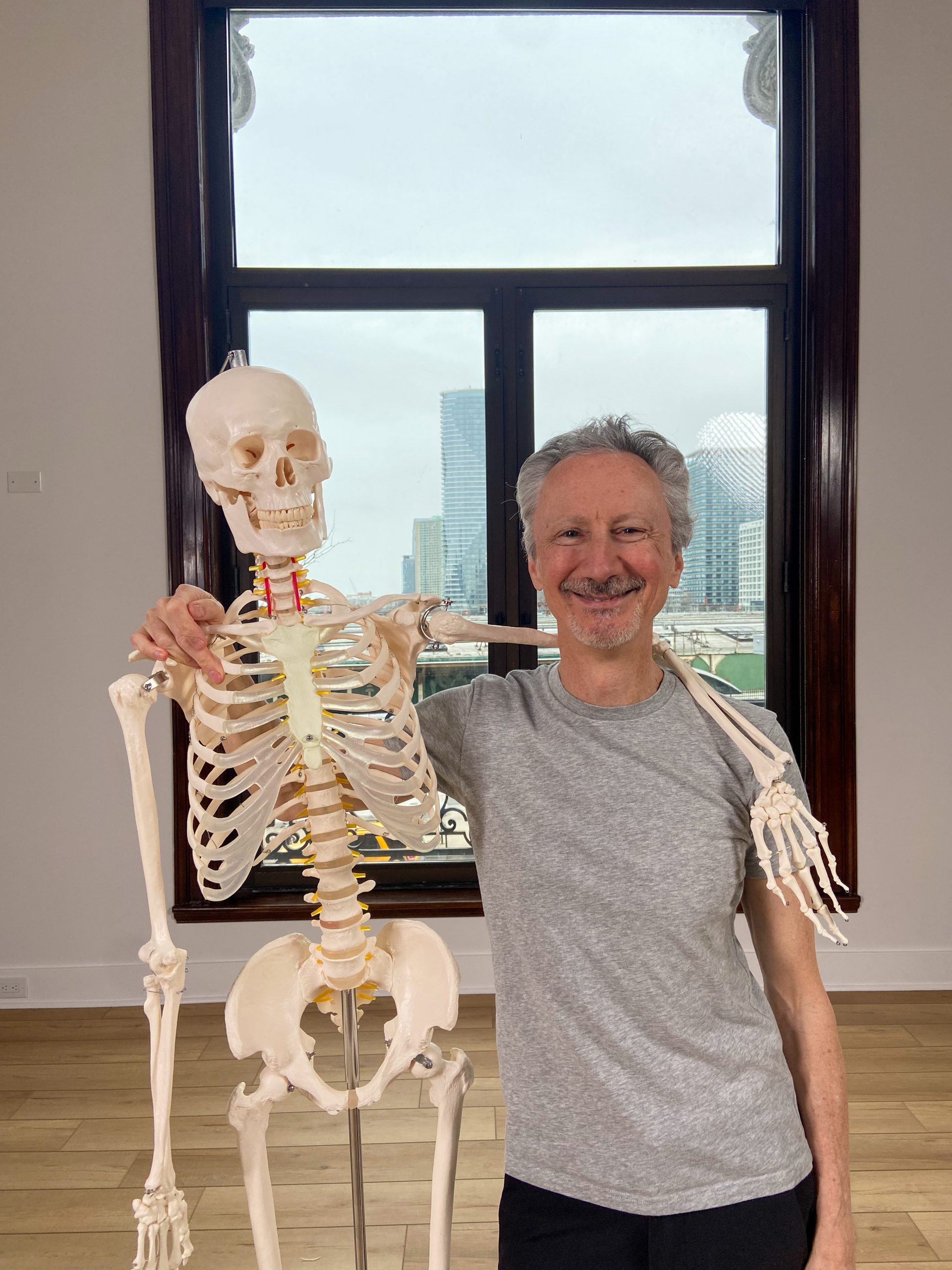 Joe Miller holding an anatomy skeleton