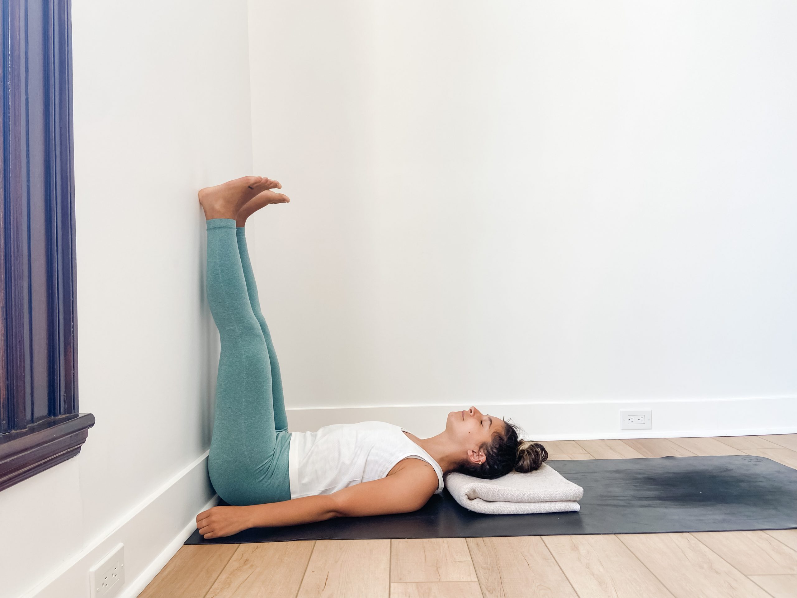 Yogi in legs up the wall pose (Viparita Karani)