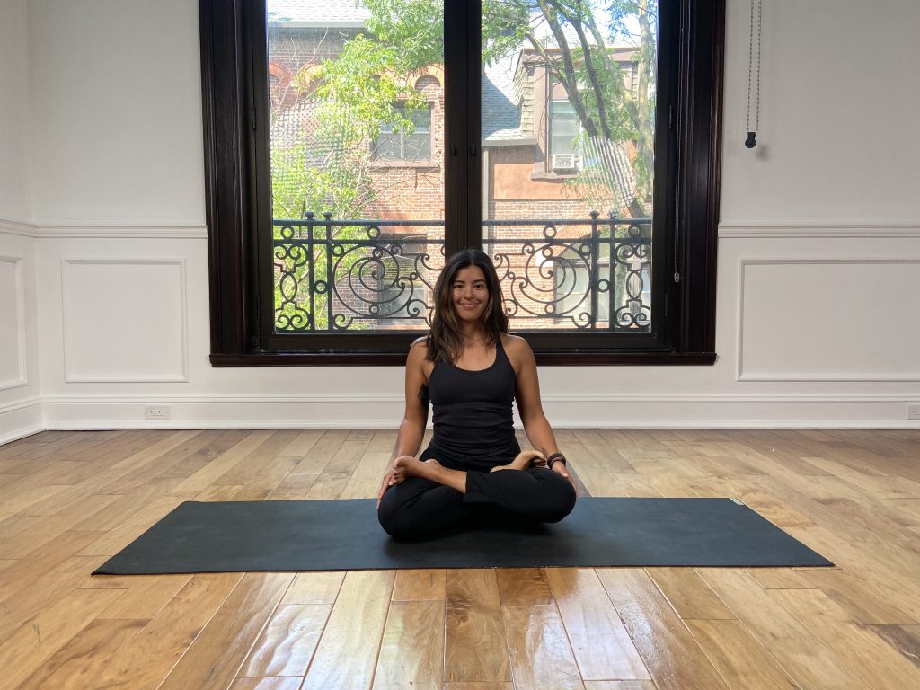 Girl in lotus pose on a yoga mat