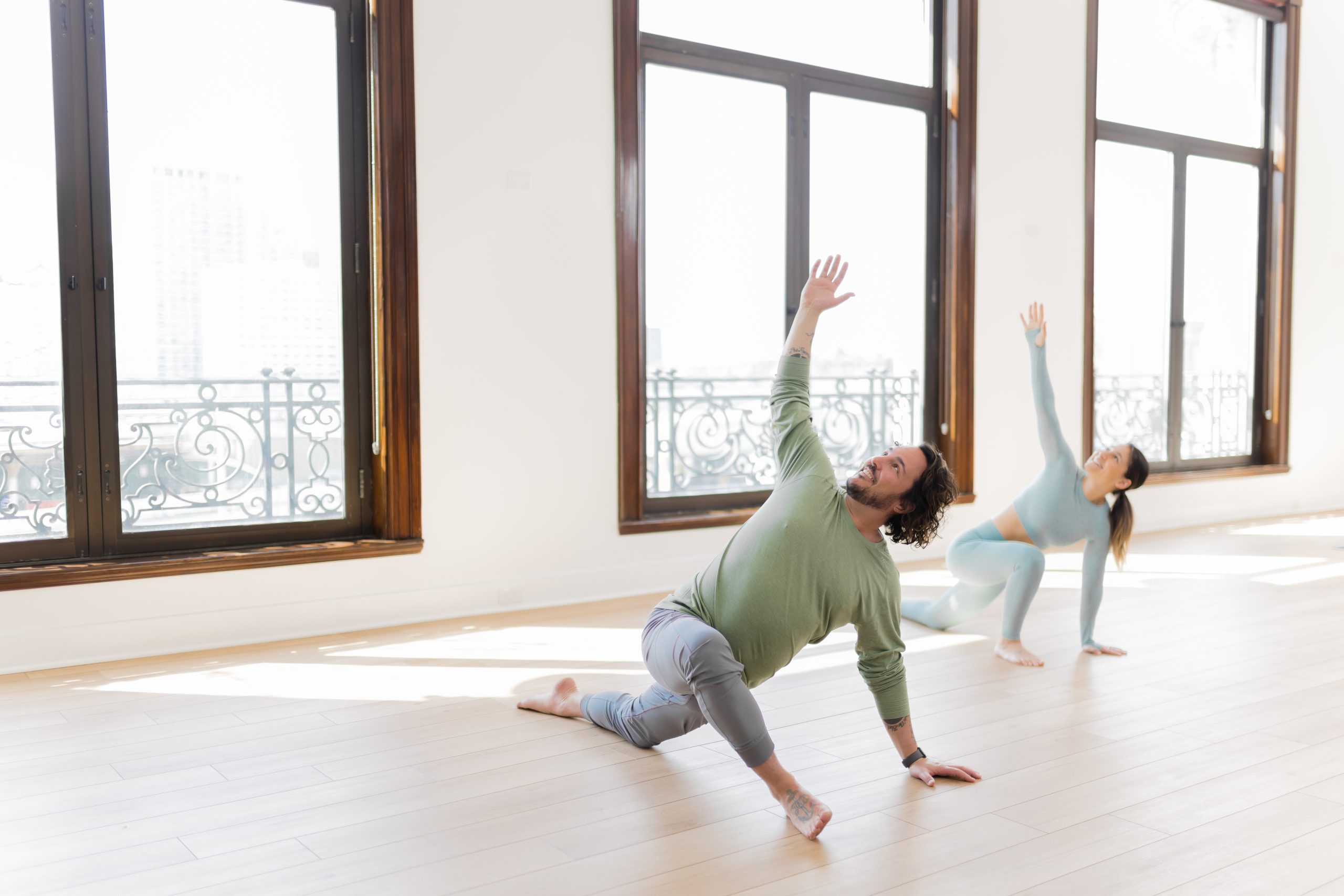 Patrick from YogaRenew teaching a student in a yoga class