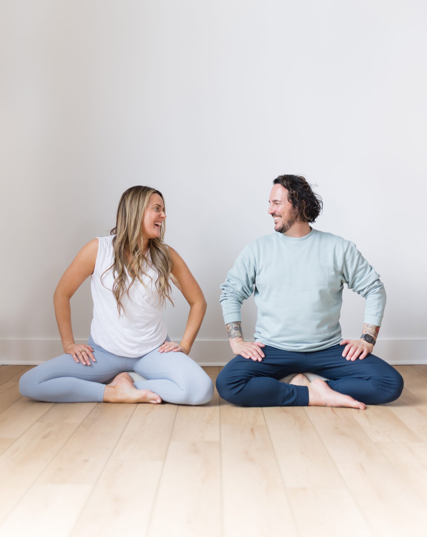 Kate & Patrick of YogaRenew looking at each other, smiling