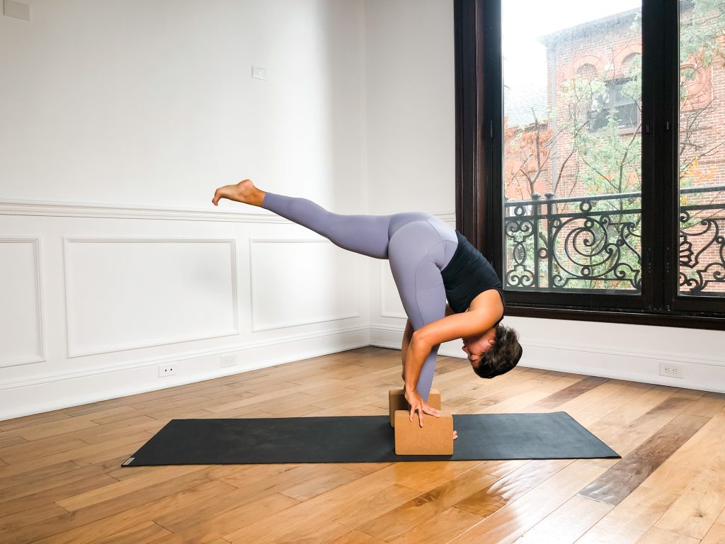 Girl in Standing Split with blocks on a yoga mat