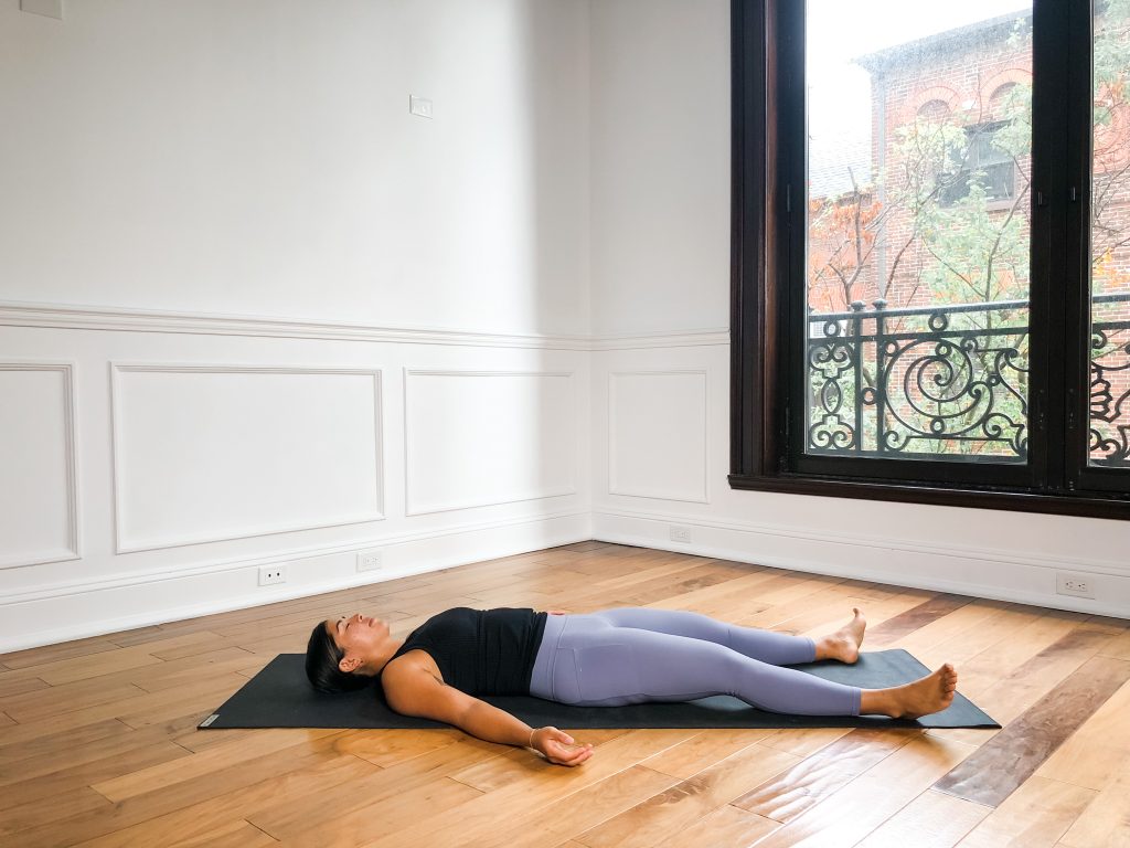 Savasana Pose on a yoga mat on the floor