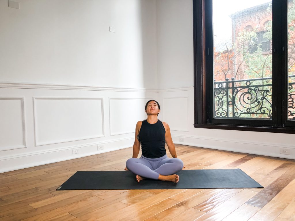 Girl in easy seat pose with her arms behind her back