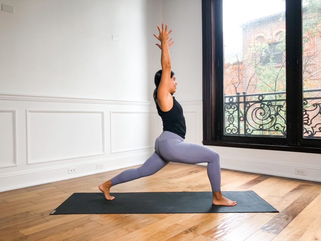 Woman on a yoga mat in High Lunge