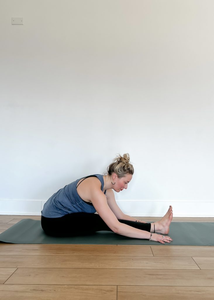 Woman in Paschimottanasana (Seated Forward Fold)