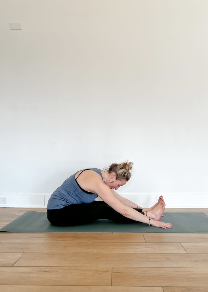 Woman in Janu Sirsasana (Head-to-Knee Pose)