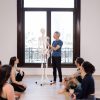Joe Miller demonstrating on a skeleton in front of 5 yogis for the Bodily Systems & Yoga Workshop