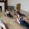 Moms in a prenatal yoga class holding their bellies