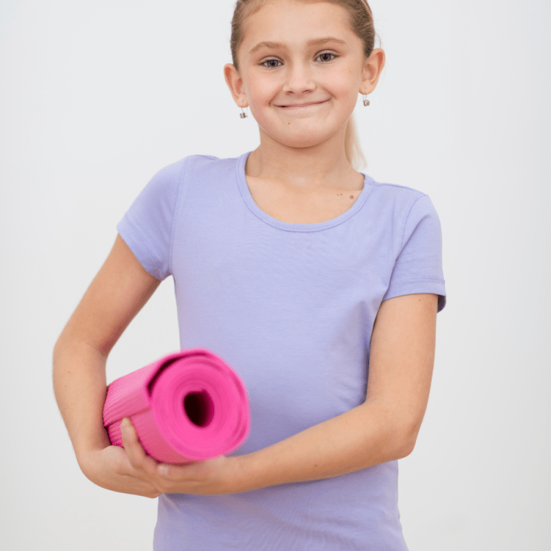 young girl with a yoga mat