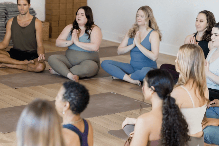 Yogis sitting meditating to quiet the Citta