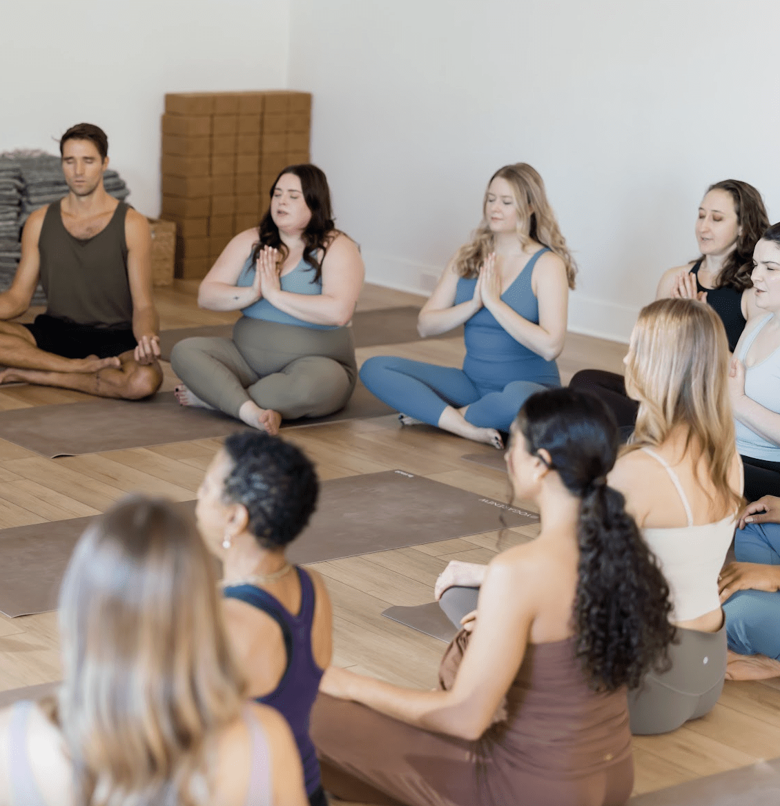 Yogis sitting meditating to quiet the Citta