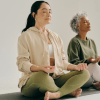 2 women meditating to promote a Mindfulness Online Course - Certification & Benefits