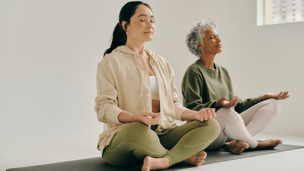 2 women meditating to promote a Mindfulness Online Course - Certification & Benefits