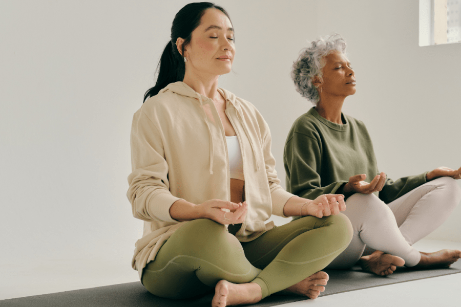 2 women meditating to promote a Mindfulness Online Course - Certification & Benefits