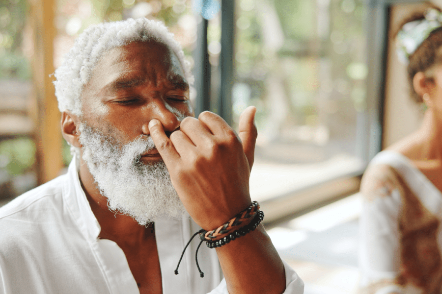Black man practicing alternate nostril breathing