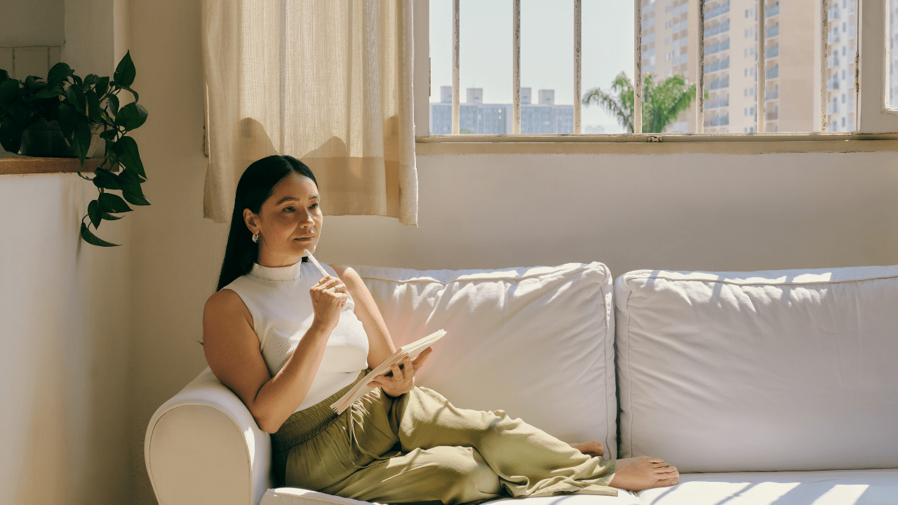 girl sitting on a couch doing her mindfulness studying from home